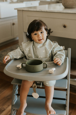 Bavette à manches longues avec pochette intégrée