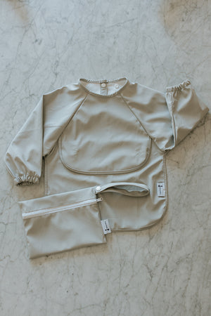 Bavette à manches longues avec pochette intégrée